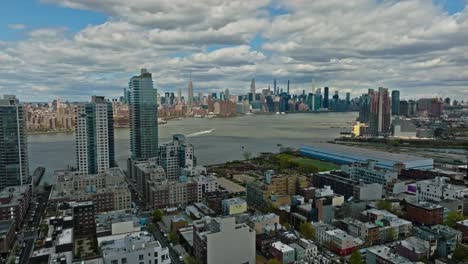 slow drone flight over american neighborhood in new york city with east river view and skyline view