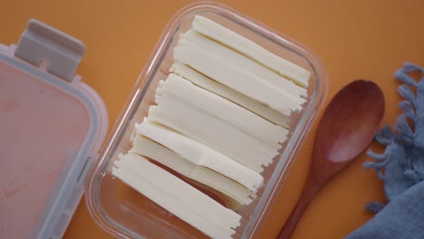 sliced cheese in a glass container