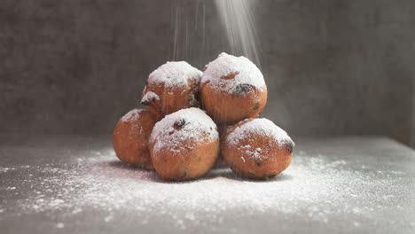 sugar powder falling on dutch oil balls delicacy with sugar powder traditionally eaten on new year's eve in the netherlands