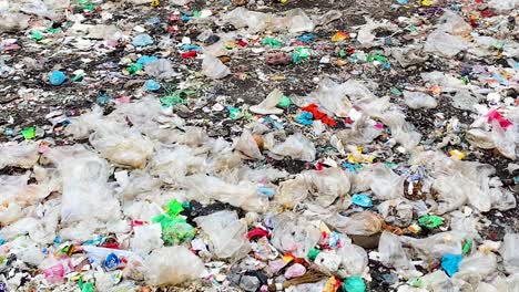 Panning-Shot-on-Clusters-of-Plastic-Waste-on-the-Ground