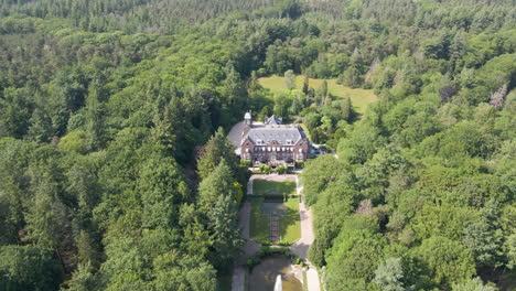 aerial of beautiful mansion with a spewing water fountain in the foreground