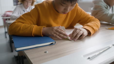 kid doing paper airplane in the classroom.