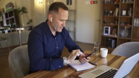 businessman in headphones communicates on the phone by video link. discussion of important matters online