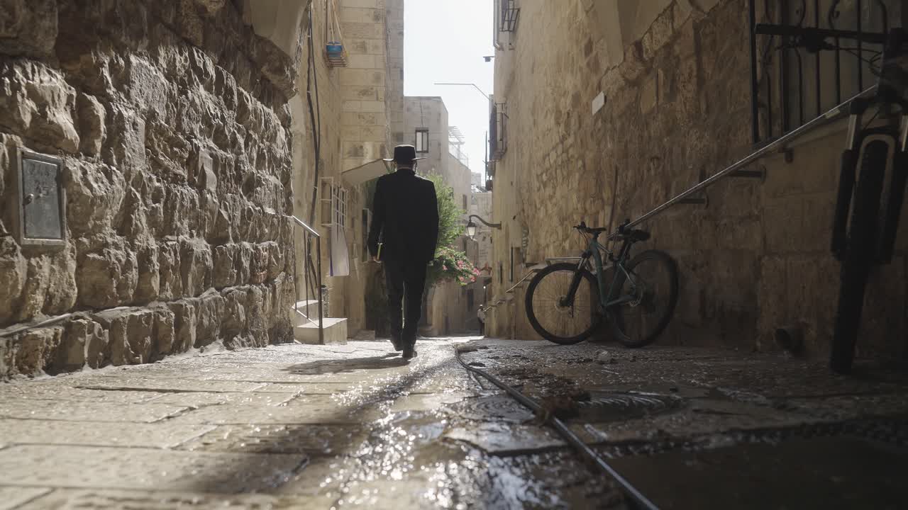 Man Walking Through the Narrow Streets of Jerusalem's Old City