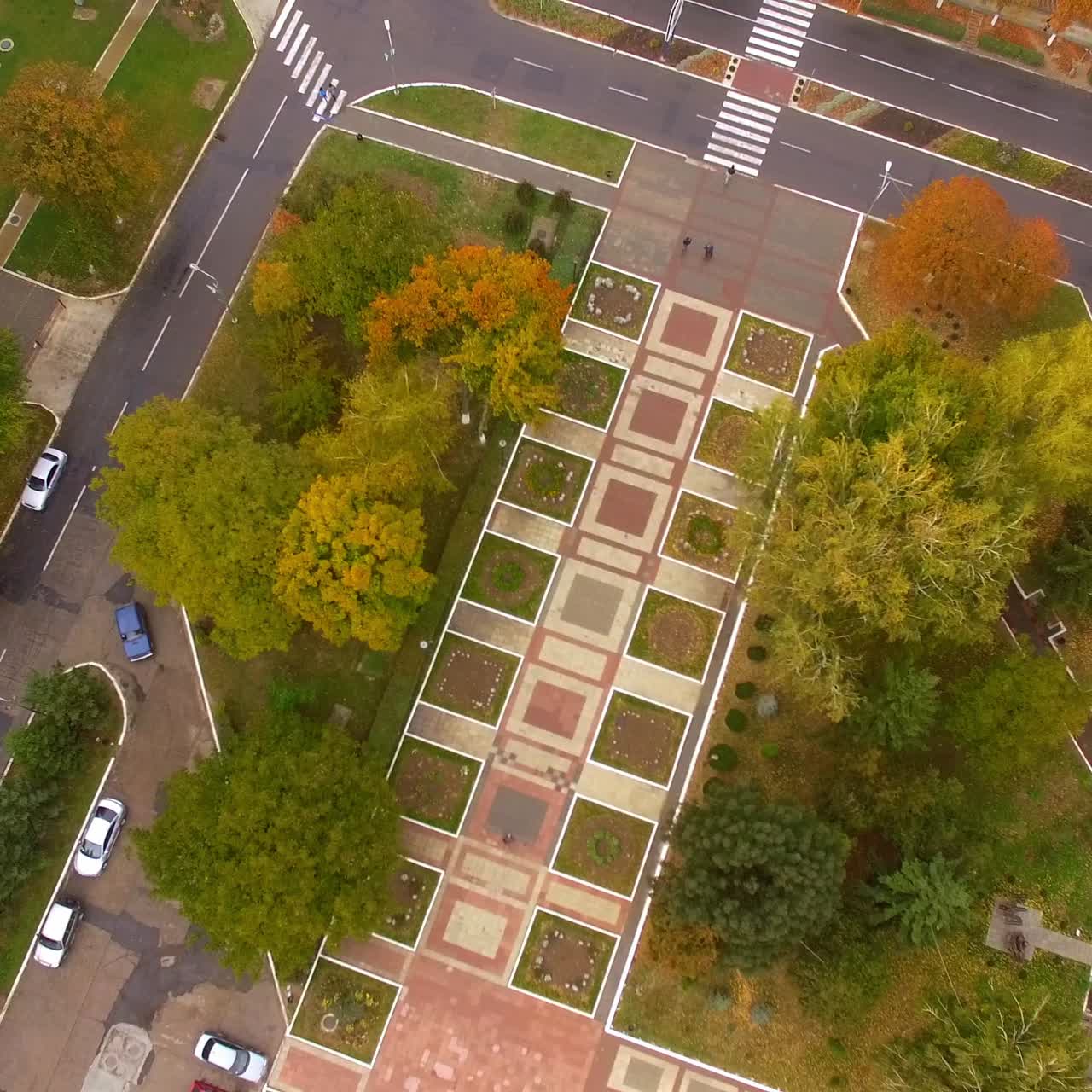 Beautiful park zone in the colors of bright autumn. Peaceful city with calm traffic among residential quarters