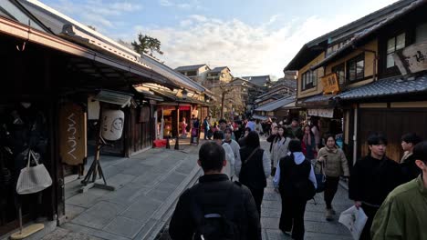 crowded historic street with pedestrians and shops