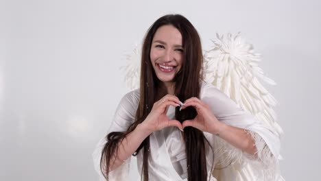 Woman with Angel Wings Making Heart Shape