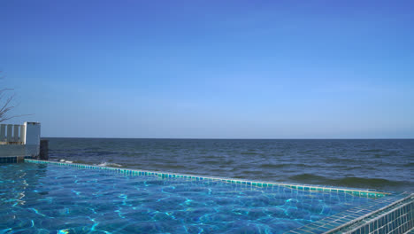 swimming-pool-with-sea-and-blue-sky-background