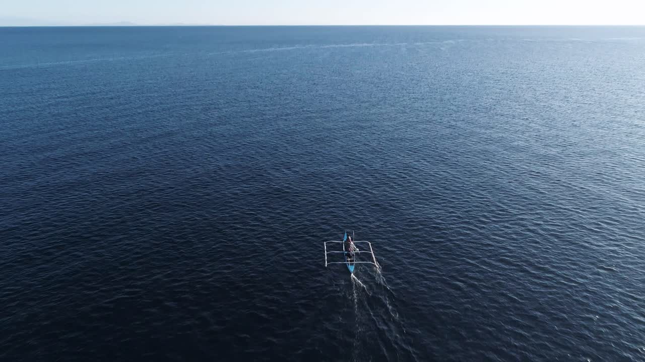 Traditional Bangka boat in blue ocean water, voyage of fisherman in open sea