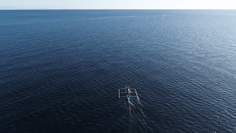 traditional bangka boat in blue ocean water, voyage of fisherman in open sea