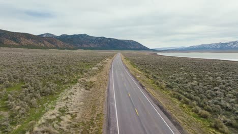 aerial - truck on highway next to scipio lake, utah, wide shot reverse