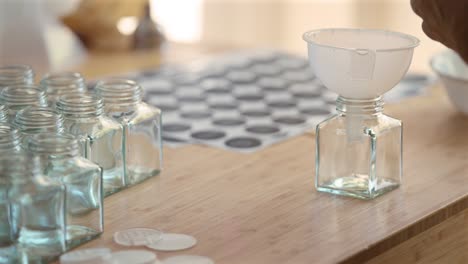 sorting spices and herbs in individual clear containers with labels