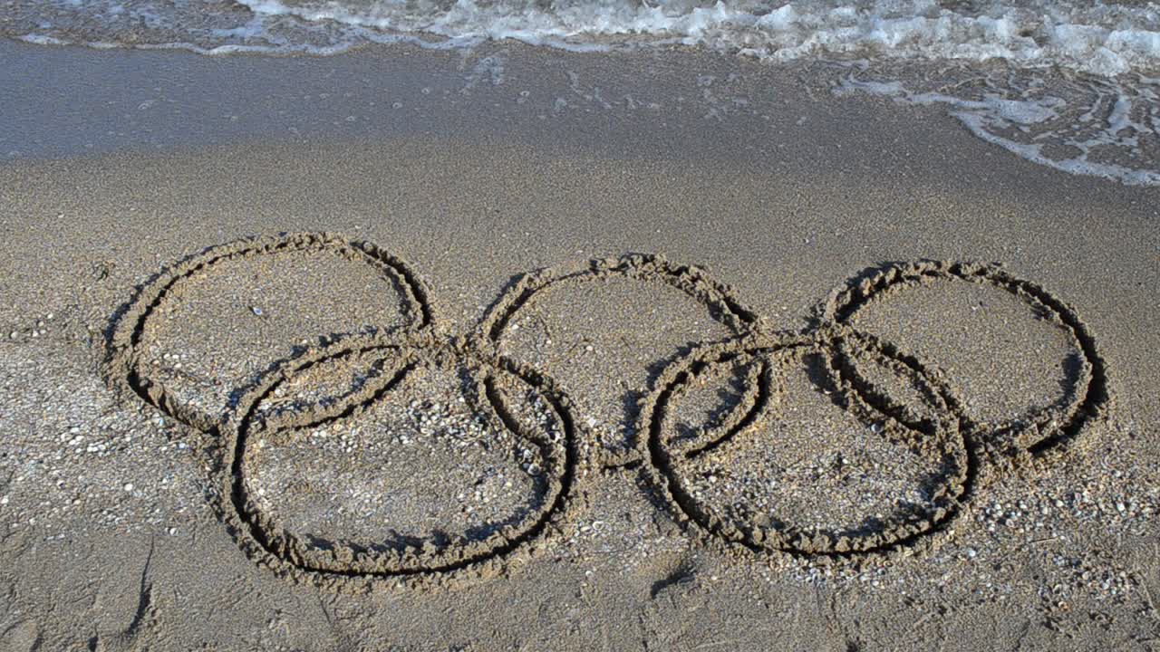 Five rings on sand, the beach. Symbol Olympic game on sand, the beach