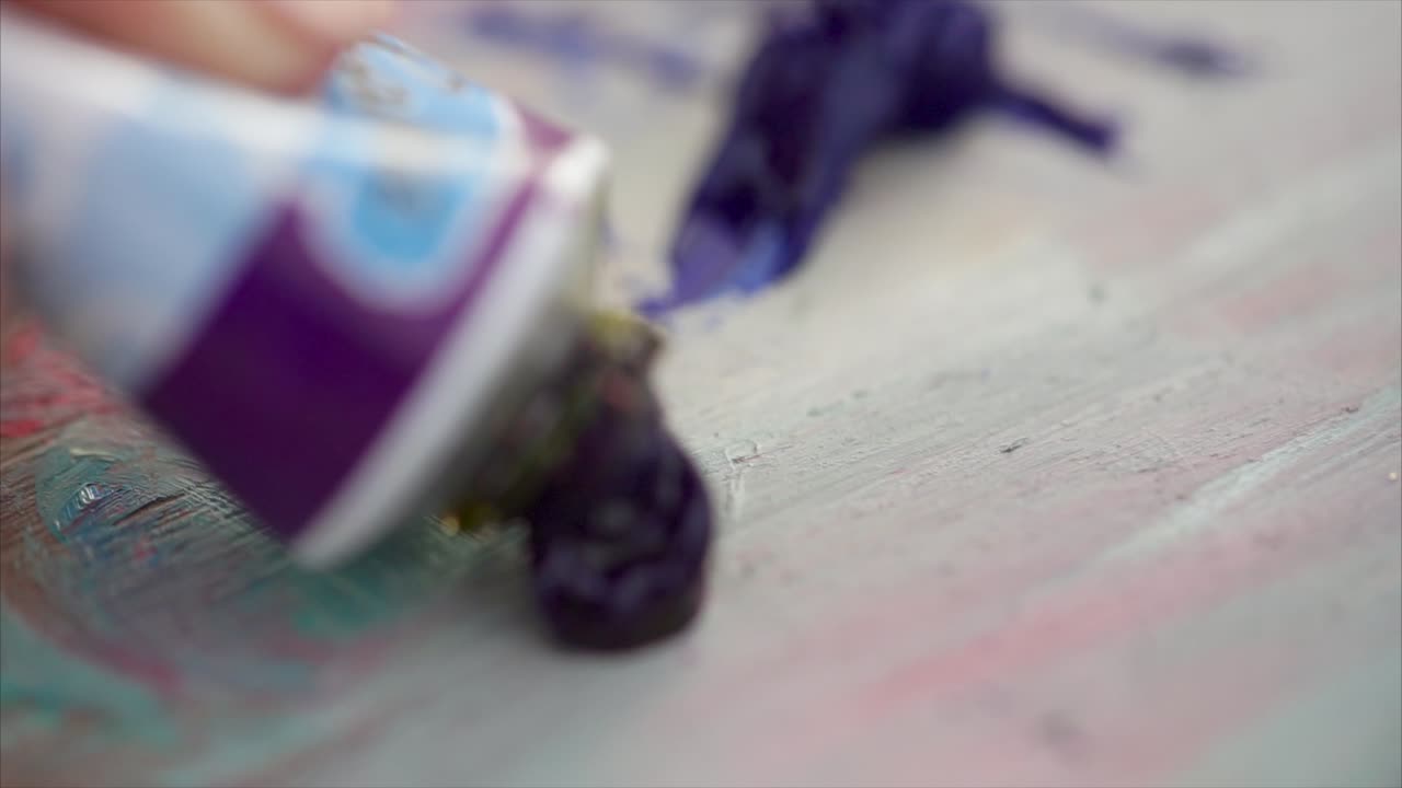 Applying Purple Paint to a Painting Palette