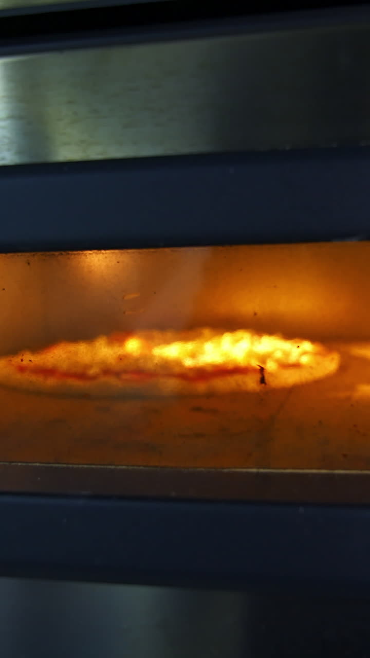Italian pizza cooked in oven. Traditional way baked italian pizza in oven. Vertical video