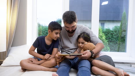 father, son and daughter in the living room.