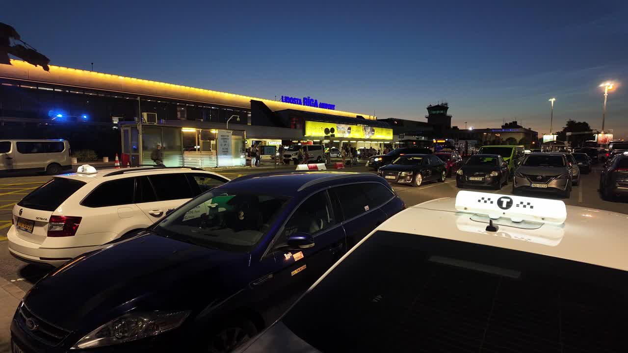 Taxis and Cars at Riga Airport Terminal at Dusk