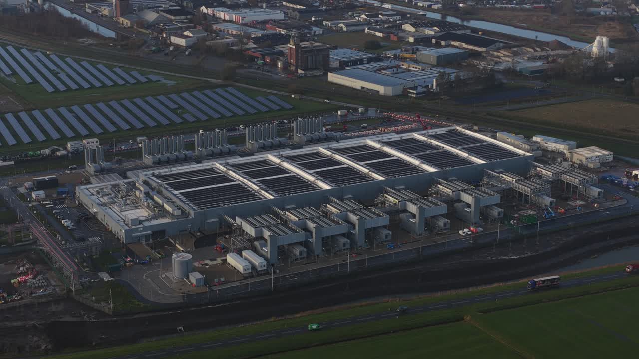 aerial drone footage of industrial data processing and computing at a large hyperscale data center in Winschoten, The Netherlands