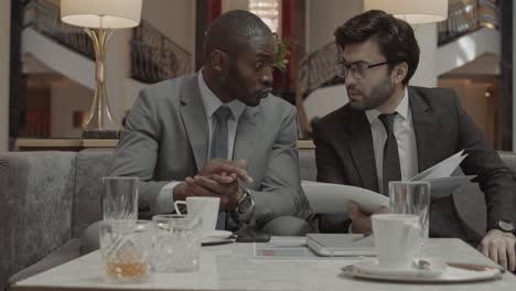 businessmen working with papers on meeting