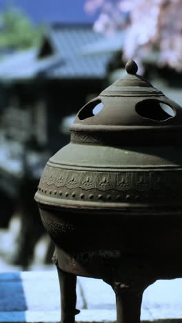 close-up of a traditional incense burner in a japanese temple