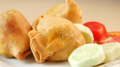 crispy samosas with tomatoes and cucumber