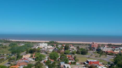 Drone-moving-over-the-building-along-the-coastline-beach