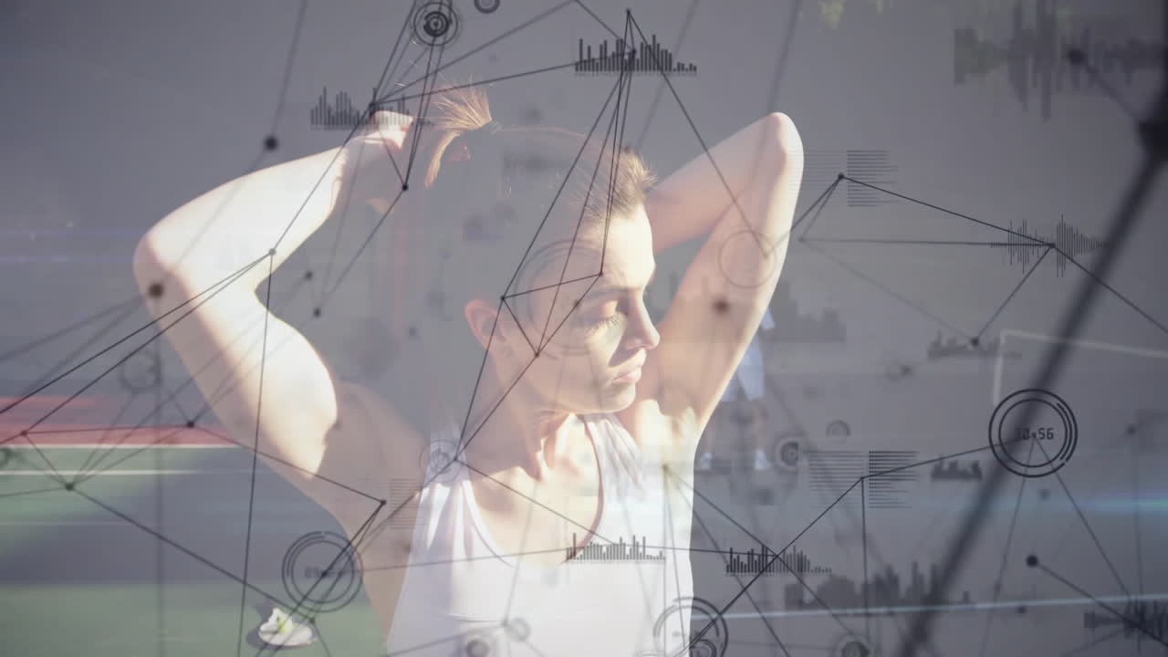 Woman stretching arms behind head beside man swinging racket on court showing tech overlay charts