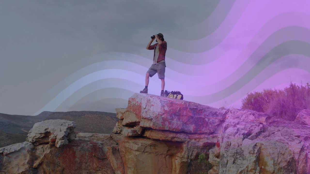 Male hiker exploring using binoculars on rocky cliff, with animated graph, map icons in travel tech