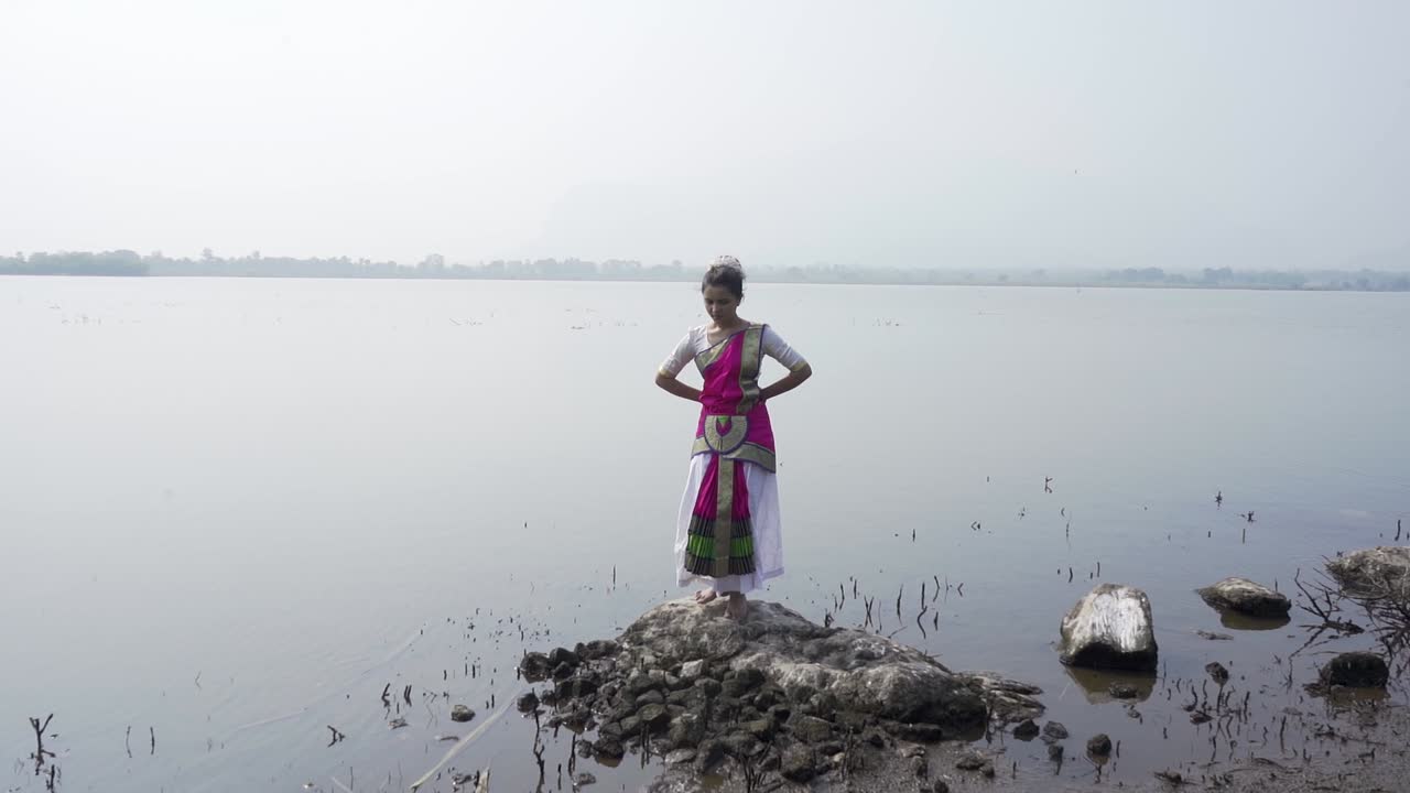 A bharatnatyam dancer displaying a classical bharatnatyam pose in the nature of Vadatalav lake, Pavagadh