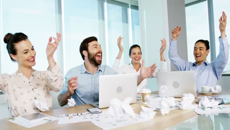 Business-colleagues-throwing-crumpled-paper-in-air