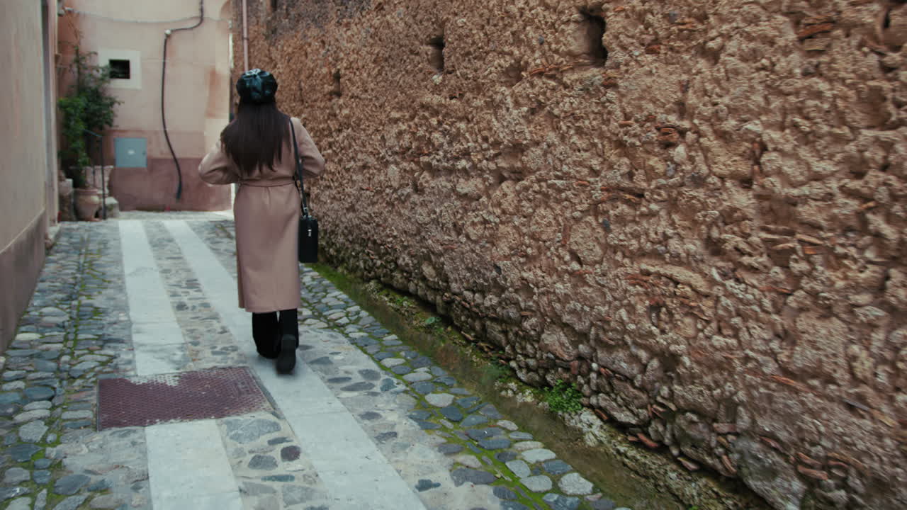 Woman Walking Home In The Streets Of Her Small Town