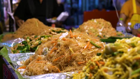 Several-piles-of-stir-fried-noodles-on-the-side-of-the-street-in-Asia