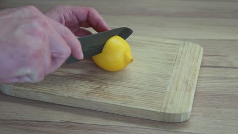 man cutting a lemon on the chopping board