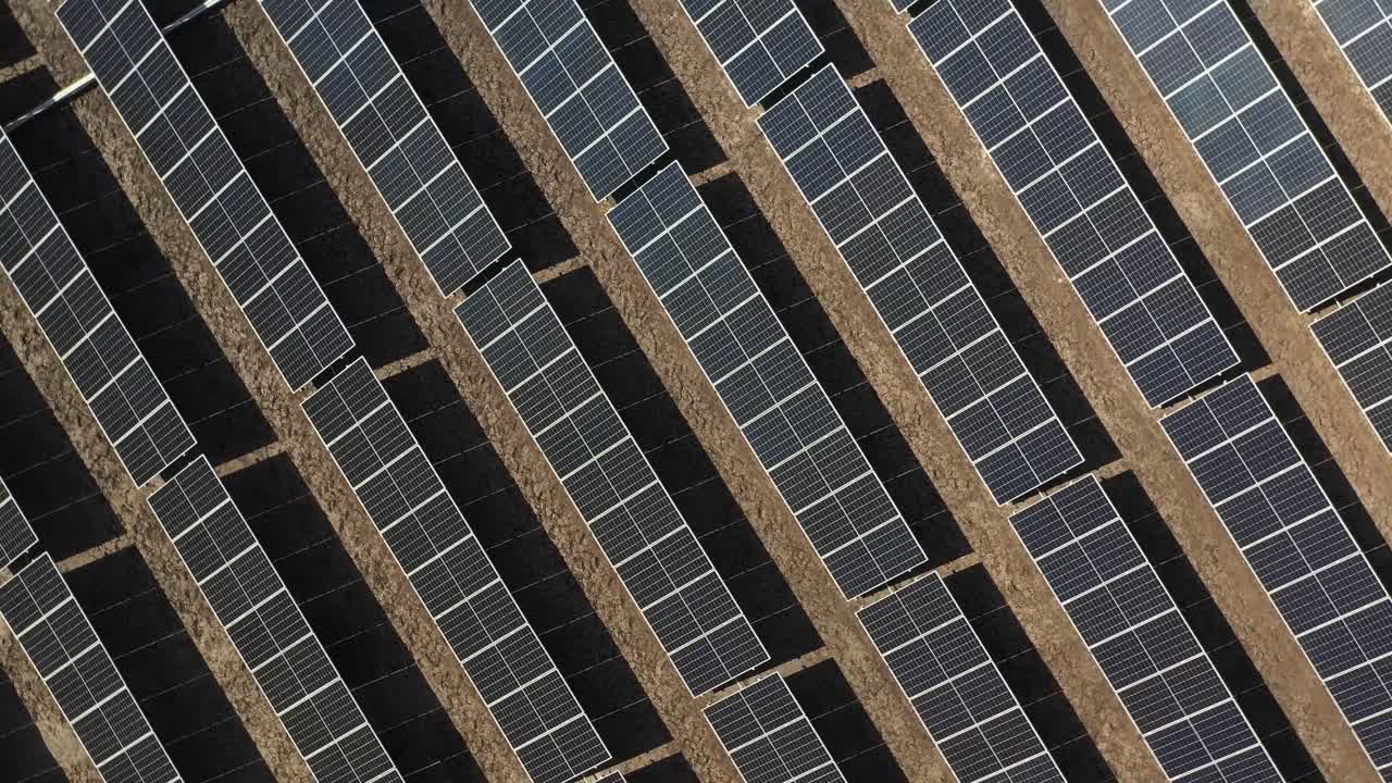 aerial 360 degree view of large solar farm, farmland agrivoltaic technology allows both farm and solar energy.4k video
