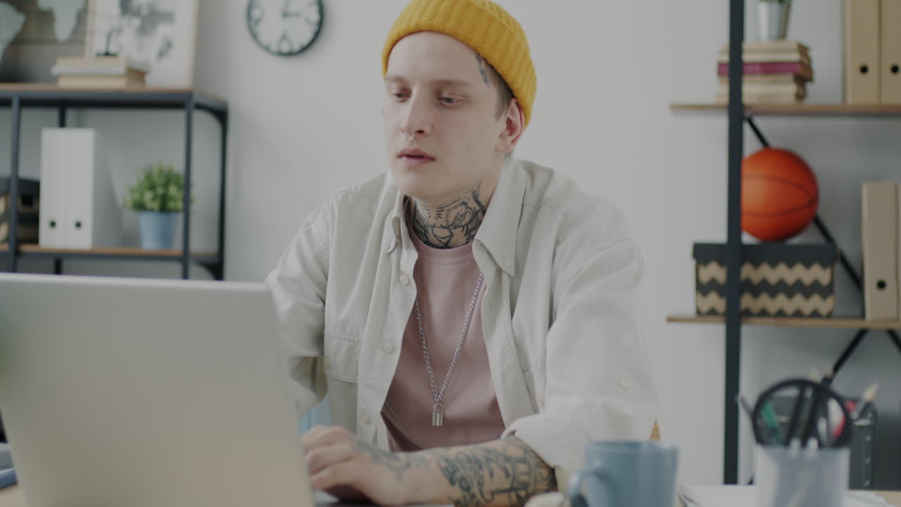 Young Person Working on Laptop in Modern Home Office