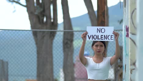 no violence sign activist protest to stop war by woman from latin america