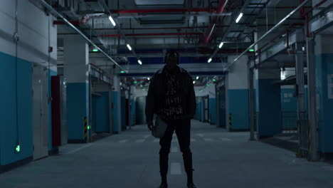 young black american rapper stands cool and still in underground garage parking