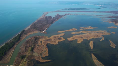 small islands with dry herbs inside the lagoon with shallow water where fish grow and birds nest in albania