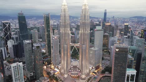 aerial of cityscape skyline illuminated at night with famous twins tower petronas in klcc central district