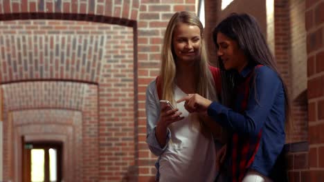 two happy students chatting to each other