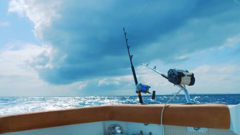 fishing rods trolling in tumultuous caribbean sea with storm clouds gathering