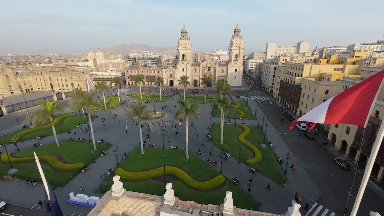 Aerial view of Lima's Plaza Mayor, showcasing historic colonial buildings, lush gardens, and palm trees. Ideal for travel blogs, editorial use, or cityscape prints.