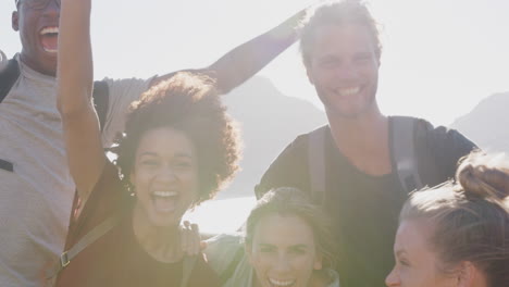 Portrait-Of-Friends-Hiking-Along-Coastal-Path-Standing-On-Cliffs-Against-Flaring-Sun