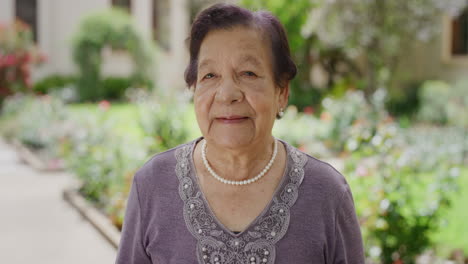 portrait-of-beautiful-elderly-woman-in-sunny-garden-looking-happy-wearing-elegant-pearl-necklace-enjoying-retirement-lifestyle