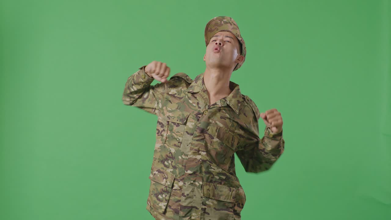 Asian Man Soldier Dancing While Standing In The Green Screen Background Studio