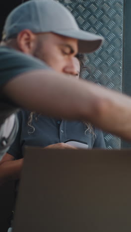 logistics workers handling packages and using a tablet