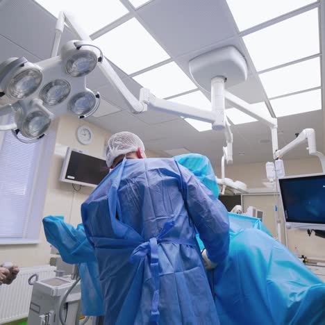 group of doctors perform an operation to a patient. surgeons in medical uniform and masks working in the operating room.