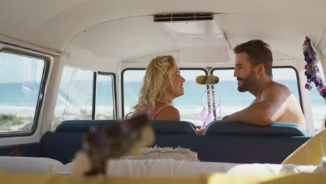 young adult couple sitting in a camper van 4k