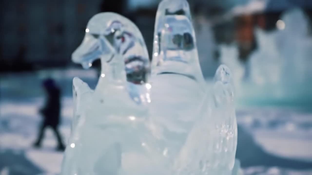 Participants admire detailed ice sculptures at an annual winter festival. The frosty atmosphere highlights creative artistry and craftsmanship of local sculptors.