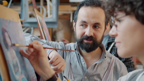 art instructor guiding student in painting class